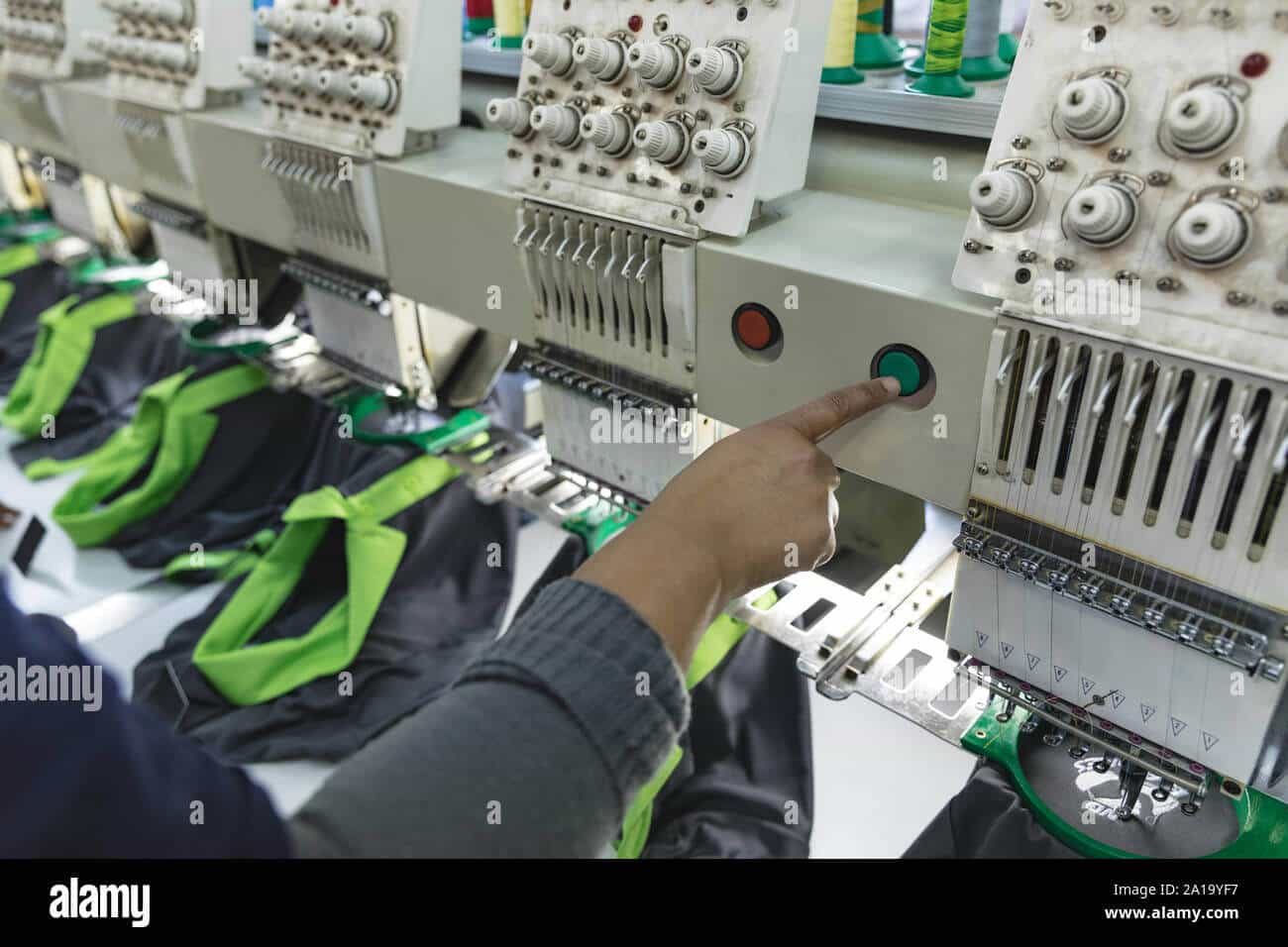 woman operating a machine in a sporswear clothing factory